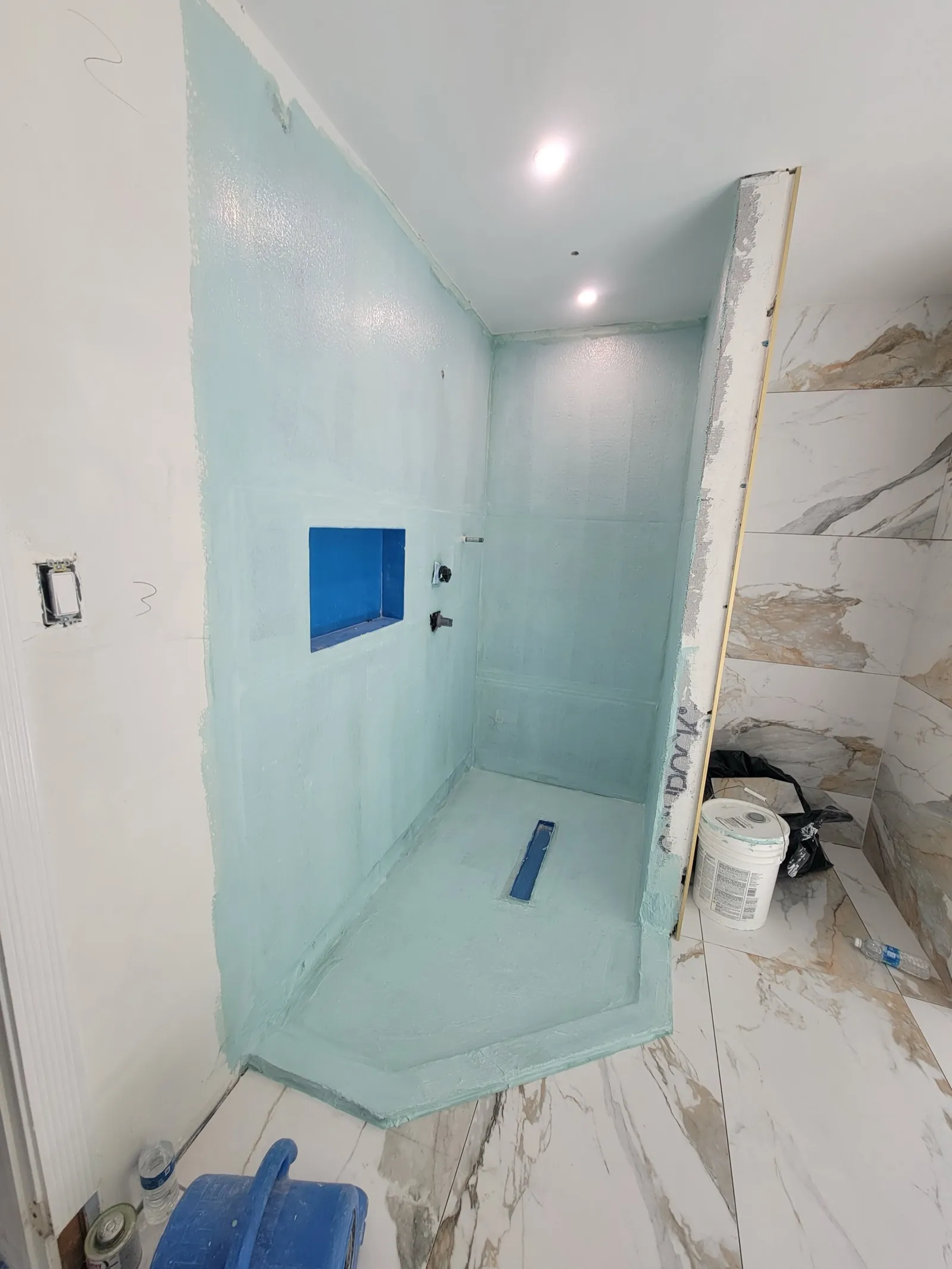 Shower waterproofing installed before tile in a bathroom remodel
