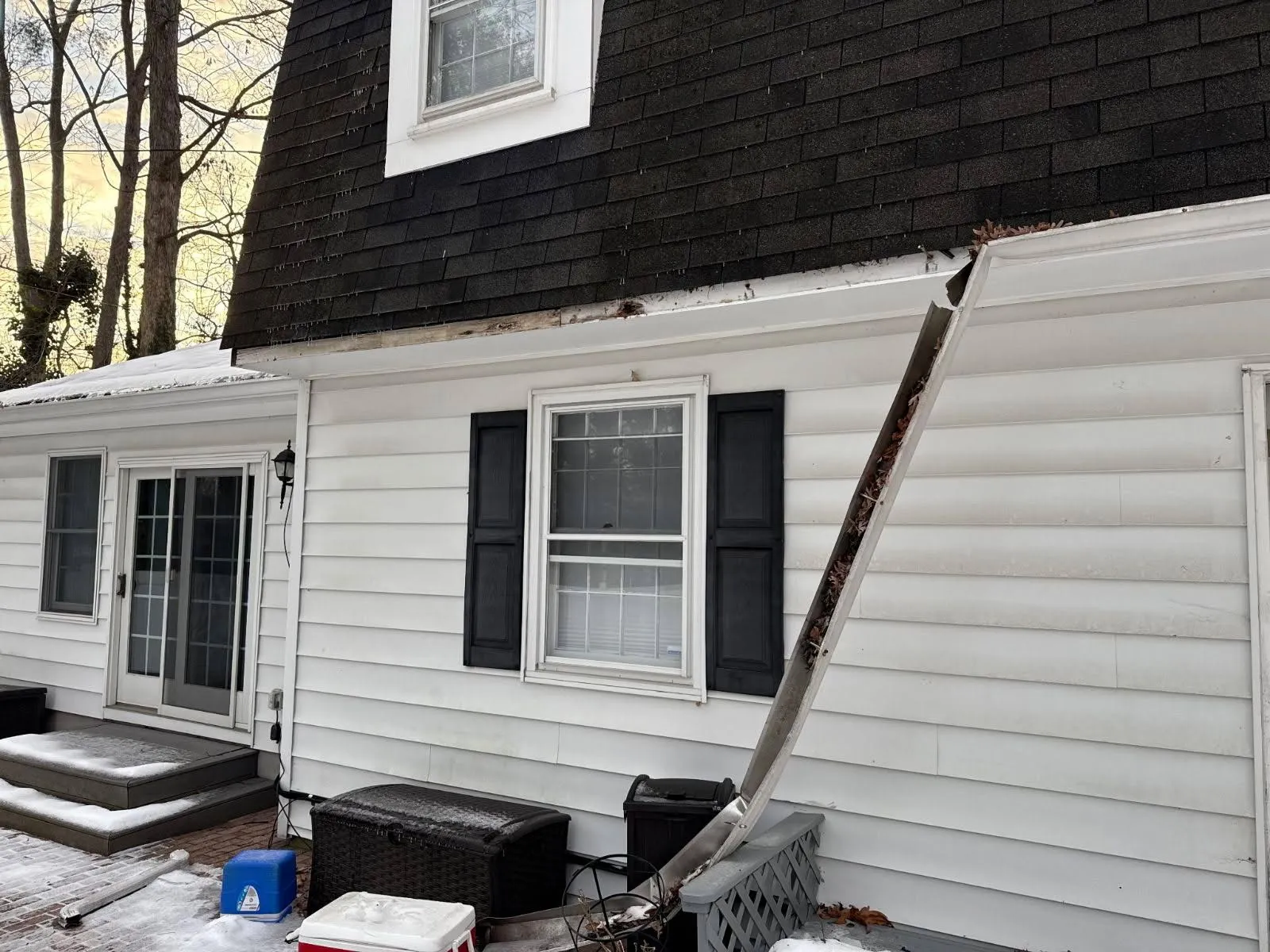 Siding repair around a dormer and gutter line